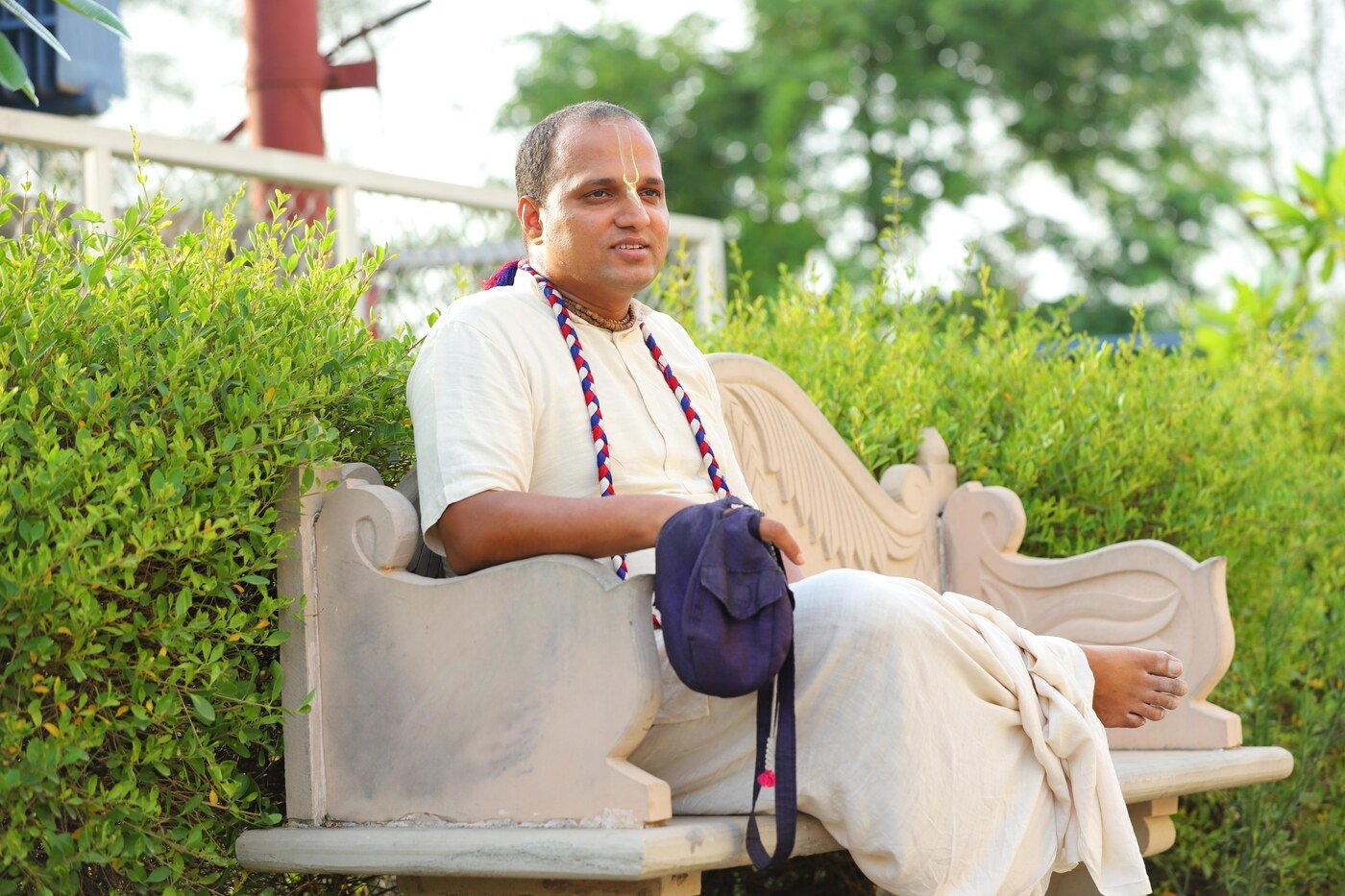 Brajsundar Das seated outdoors in Vrindavan, India